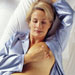 woman-bed-breast-self-exam
