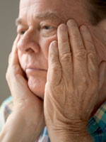 elderly-man-hands-face