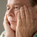 elderly-man-hands-face
