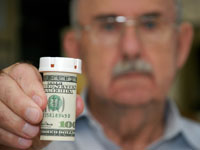 senior-man-perscription-bottle-money
