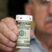 senior-man-perscription-bottle-money