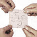 four-hands-puzzle-pieces-together