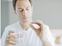 man-taking-pill