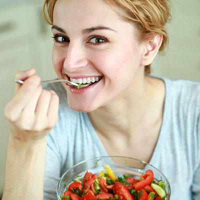 woman-smiling-eating-salad