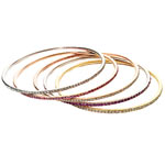 White, yellow or rose gold bangles with sapphires or diamonds, Cynthia Wolff.
