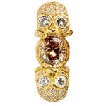 Double-skull ring, two facing skulls in an etched band of 18kt gold and diamonds, Loree Rodkin.