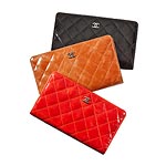 Quilted lambskin clutch wallets in red, tan and black, Chanel.