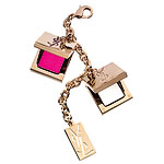 Bag Accessory Charm bracelet with fuschia lip gloss and Elle solid perfume, YSL.