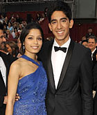 Freida Pinto in John Galliano, Judith Leiber clutch, Jimmy Choos heels, Martin Katz jewelry, Dev Patel in Burberry tuxedo, 2009 Academy Awards, Oscars, Red Carpet Arrivals
