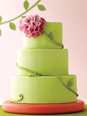 The lifelike peony curled around this threetier cake is simple yet 