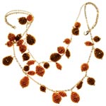 Necklace of gold-plated baubles with cotton yarn, Elizabeth Gillett Ltd..