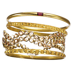 18kt gold with garnet, 18kt gold, and 18kt gold with diamond bangles, Julie Baker Design.