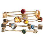 Bangles of 18kt gold with garnet, citrine, blue topaz, and green quartz, M+J Savitt.