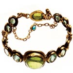 Bracelet of 18kt and 24kt gold with peridots, emeralds, tourmalines and silver, Judy Geib.