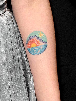 This young actress is well-armed with this colorful sunrise tattoo, 