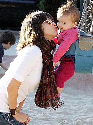 Jessica Alba tries to lay one on daughter Honor Marie while swaying on the 