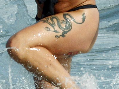 Which singer sports a dragon tattoo on her thigh? | Pink