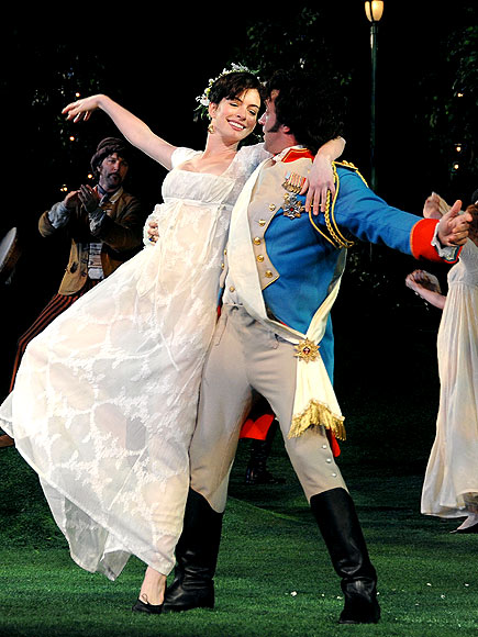 Anne Hathaway gets swept off her feet during an afterparty performance 