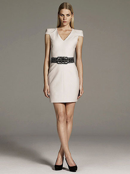 Kim Kardashian goes high-fashion in a sharp-shouldered dress, wrap
belt and lace booties. Which piece is under $100?
