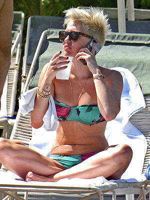 Miley Cyrus Lounges In Bikini As Split From Liam Hemsworth Rumors Swirl