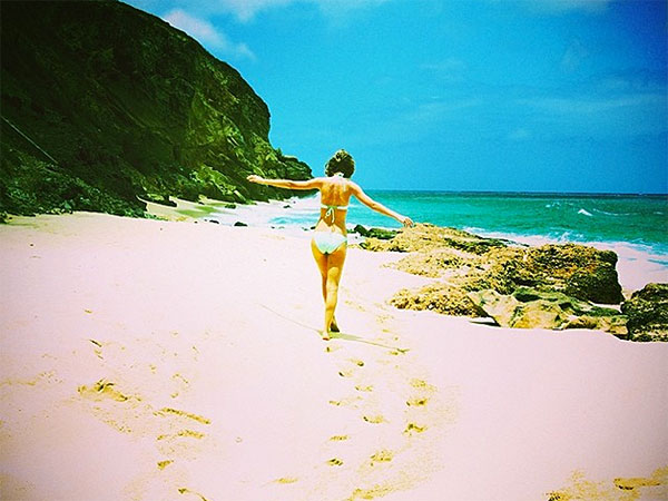 Taylor Swift Cavorts on a Tropical Beach in a Bikini