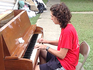 Teen's Outdoor Performance on Water-Damaged Piano Lifts Spirits After Louisiana Flood