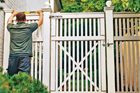 man fixing fence
