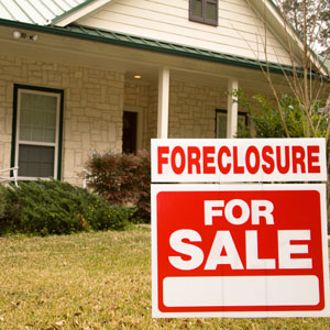 foreclosure for sale sign outside a house
