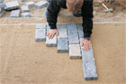 Roger Cook installing pavers