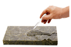 man's hand holding a dropper filled with sealant