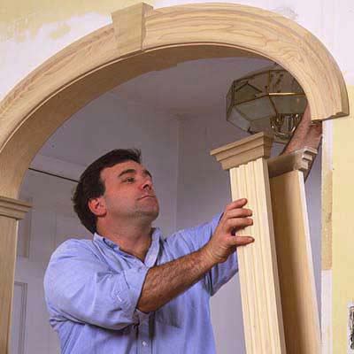 Stand the columns under the arch and slip them over the walls