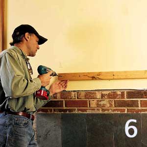 screw wooden cleat above fireplace