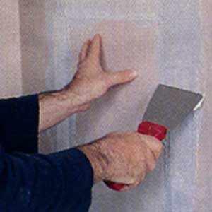 concealing the drywall cutout with tape and joint compound