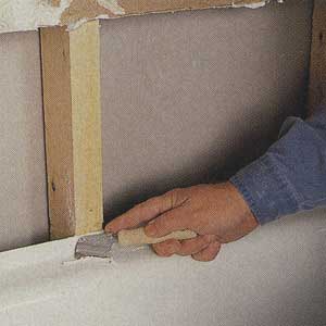 scraping caulk and soap residue from the shower base
