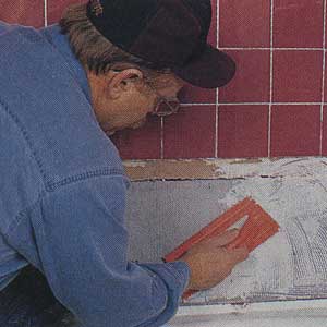 Spreading latex mastic on cement backerboard 