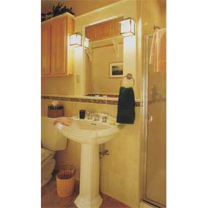 space-saving bathroom with pedestal sink and cabinets.