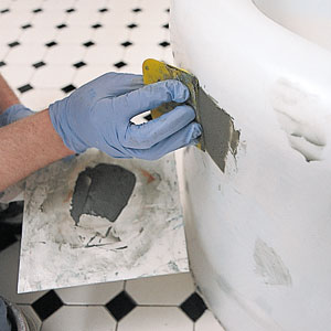 filling dings and scratches of an old tub with putty before shining