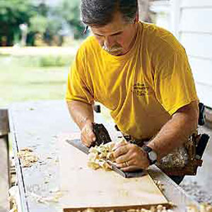 Tom Silva smoothing a board's face
