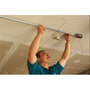 Bore a hole at location of floodlight