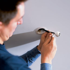 attaching the magnifying lens to the tip of the cable