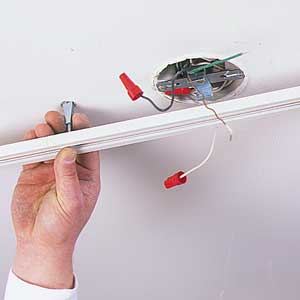 Bore holes in the ceiling and mount the track with toggle bolts