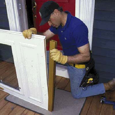 Insert the flexible rubber fin into the slot in the expander sweep and slip the expander onto the bottom of the door