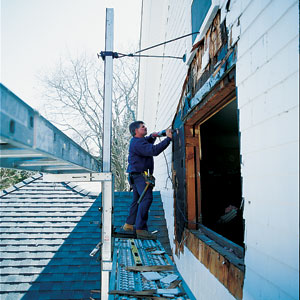 Tom Silva slices through house wall with reciprocating saw to make opening for bay window