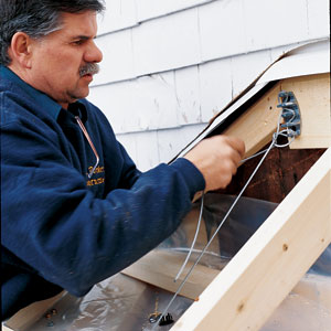 Tom Silva ties cable to bay window to keep it from sagging