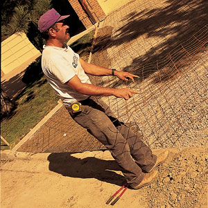 To add strength, wire-reinforcing mesh (10 gauge) is spread over the drive. It will be lifted into the concrete as the slab is poured. You can forgo the mesh by specifying a concrete mix that is fortified with plastic fiber. If the soil base is poor, steel-reinforcing rods (rebar) can be used to strengthen the slab. 