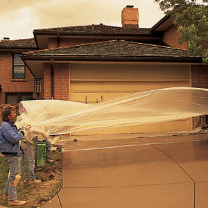 A film of plastic is laid on the driveway to keep the retarder from evaporating and to protect it in case of rain. 