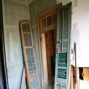 arched-top shutters in need of refurnishing