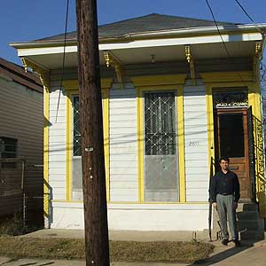 Troy Legeaux in front of his shotgun house