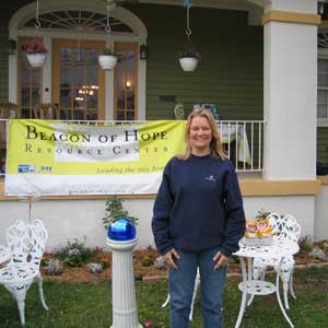Bari Landry in front of her home