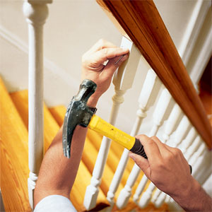 securing the top of the baluster to the rail using 2-inch hardwood trim nails